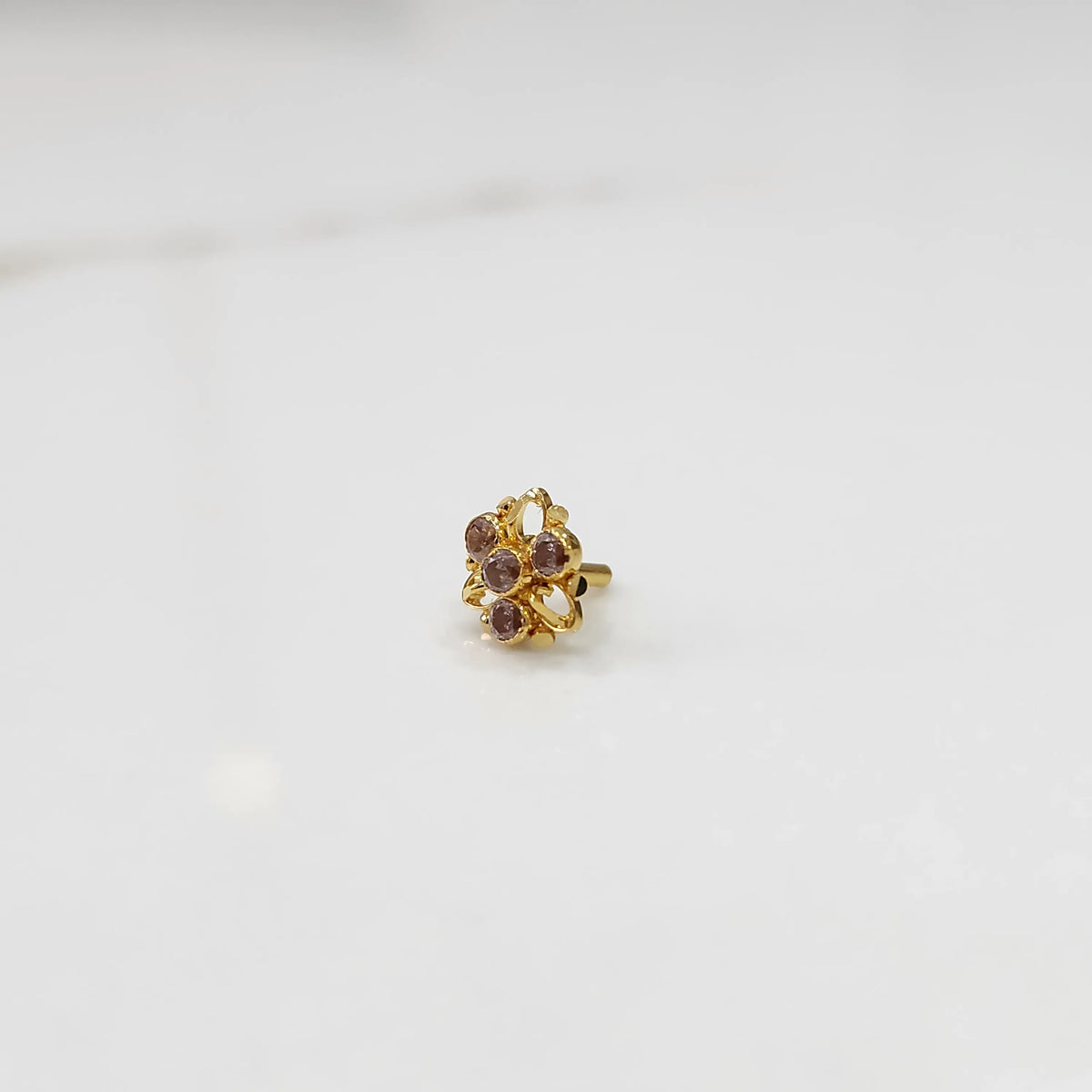 Traditional gold ring featuring an open petal design with lavender oval stones