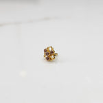 Traditional gold ring featuring an open petal design with lavender oval stones