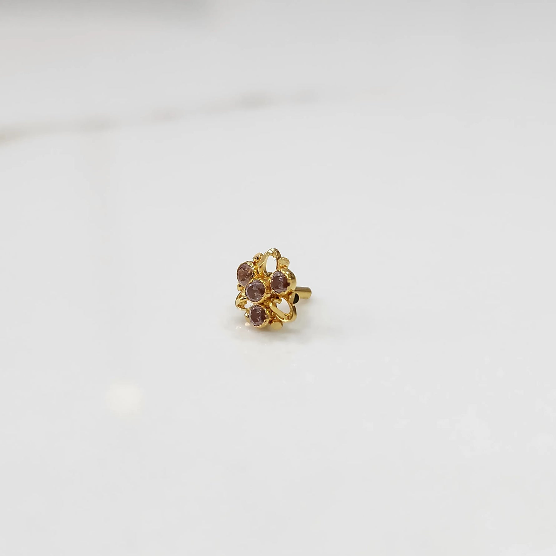 Traditional gold ring featuring an open petal design with lavender oval stones