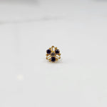 Top view of gold filigree ring with purple round gemstones