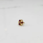 Gold filigree ring with ruby-red and clear gemstones