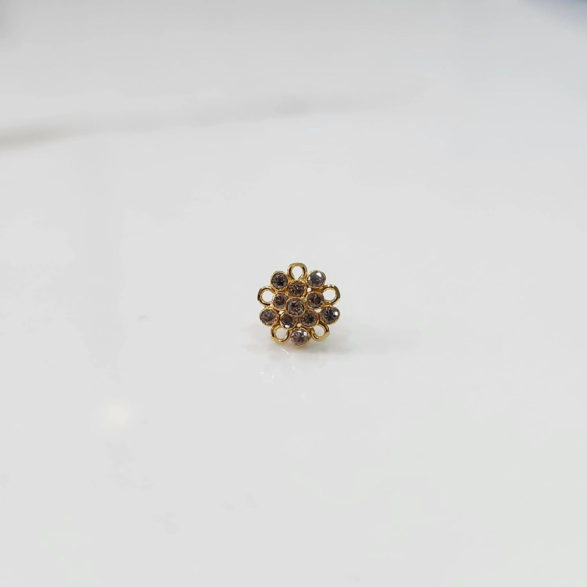 Gold floral nose pin with brown stone detailing