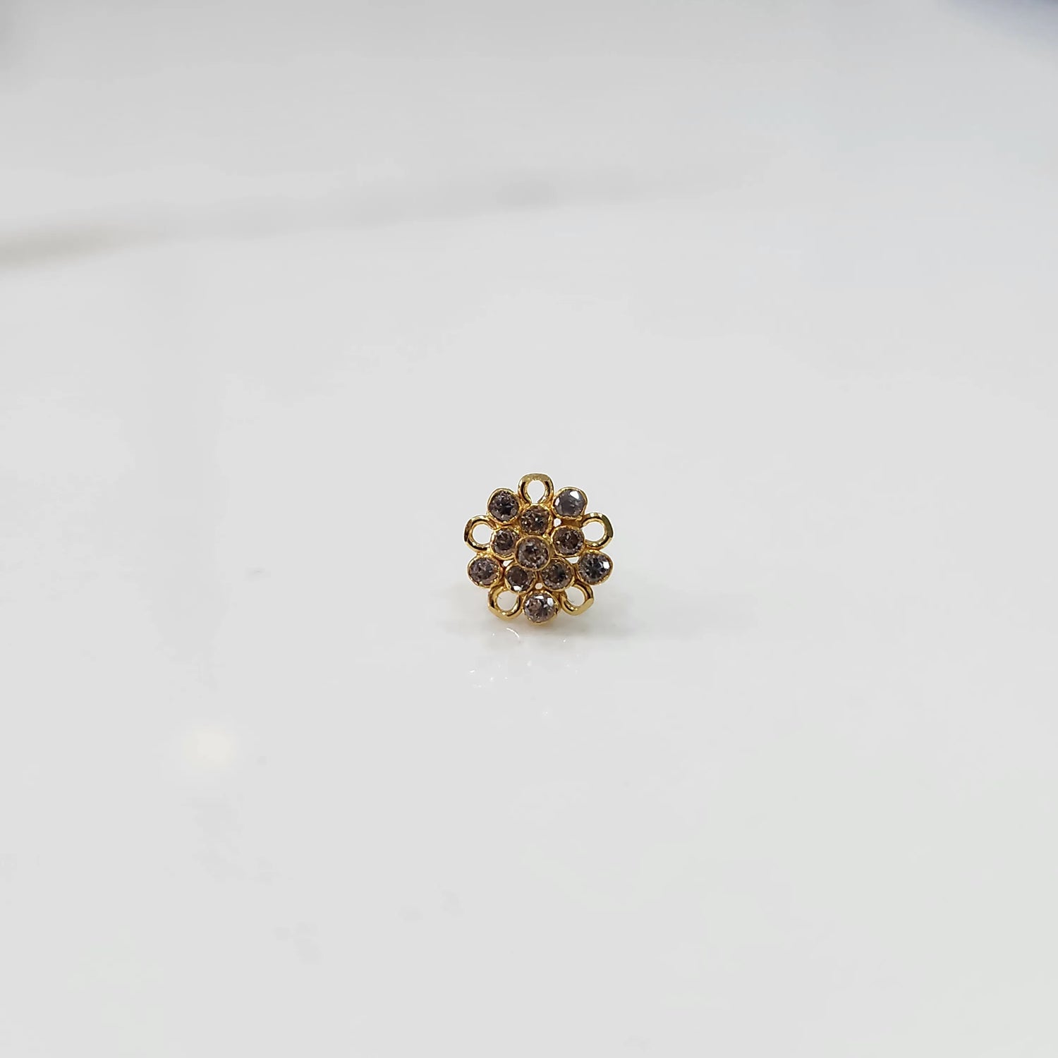 Gold floral nose pin with brown stone detailing