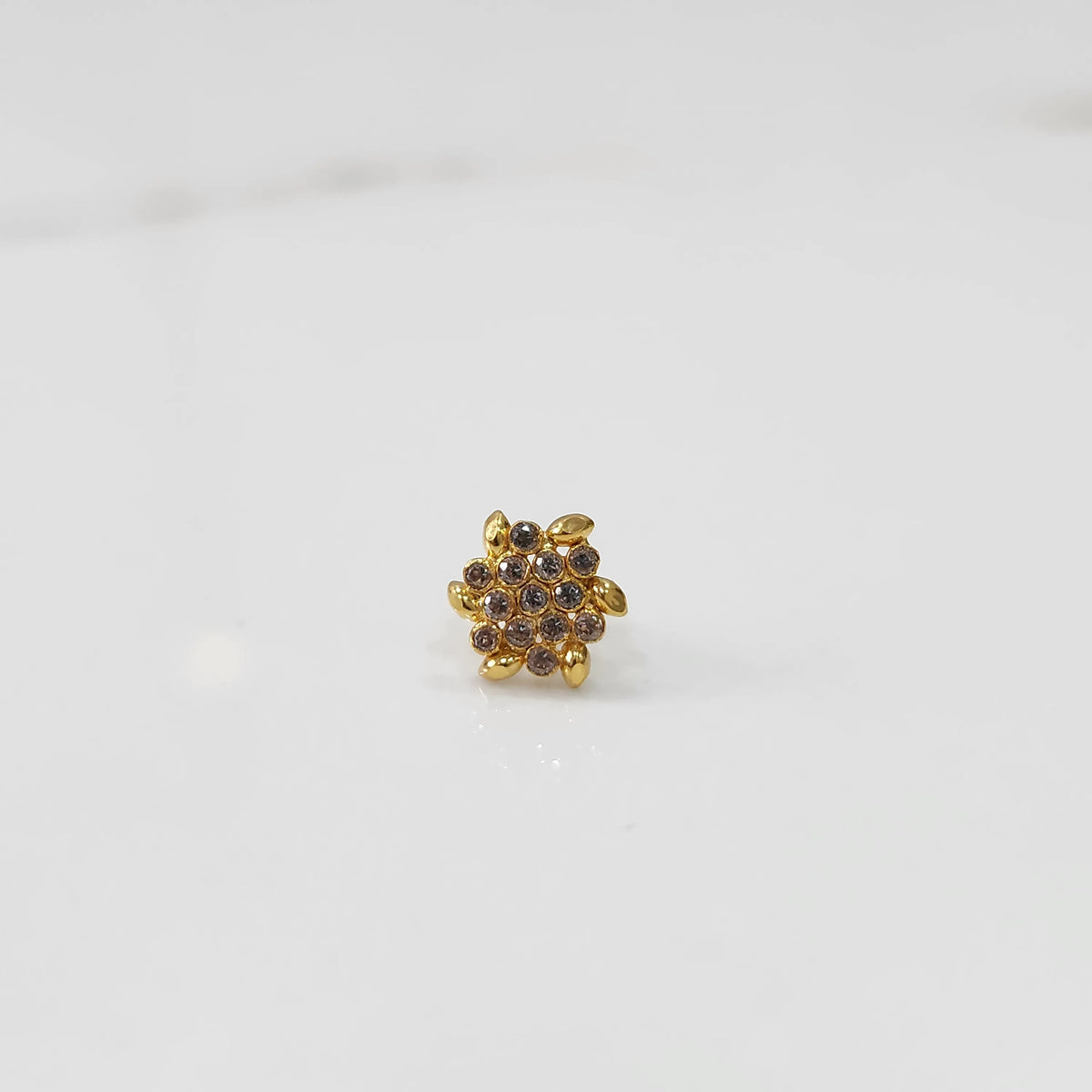 Gold-toned floral cluster cocktail ring with brown stones and leaf detailing