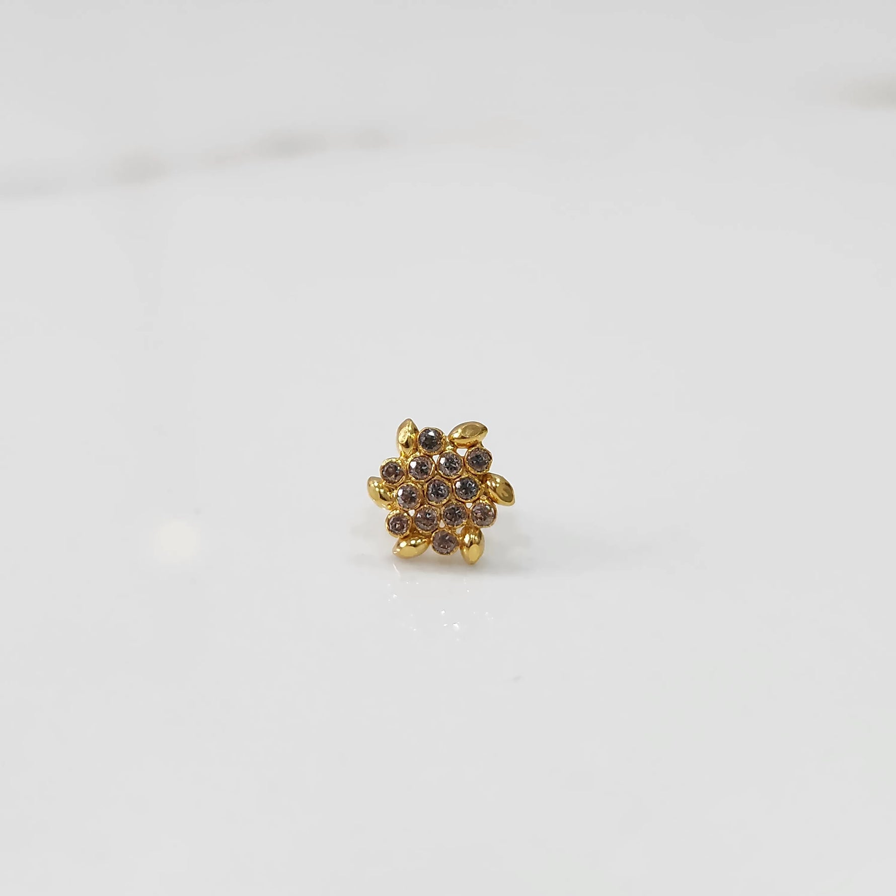 Gold-toned floral cluster cocktail ring with brown stones and leaf detailing