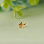 Gold floral stud earring with marquise-cut purple gemstone
