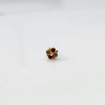 Gold floral jewelry stud with red and clear stones