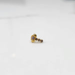 Front view of gold nose pin with pink floral head and stone trail