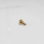 Gold nose pin with pink floral head and graduated stone trail 