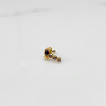 Gold nose pin with purple floral head and linear stone trail