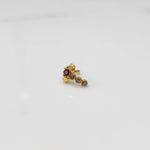 Gold nose pin with red floral head and clear stone trail