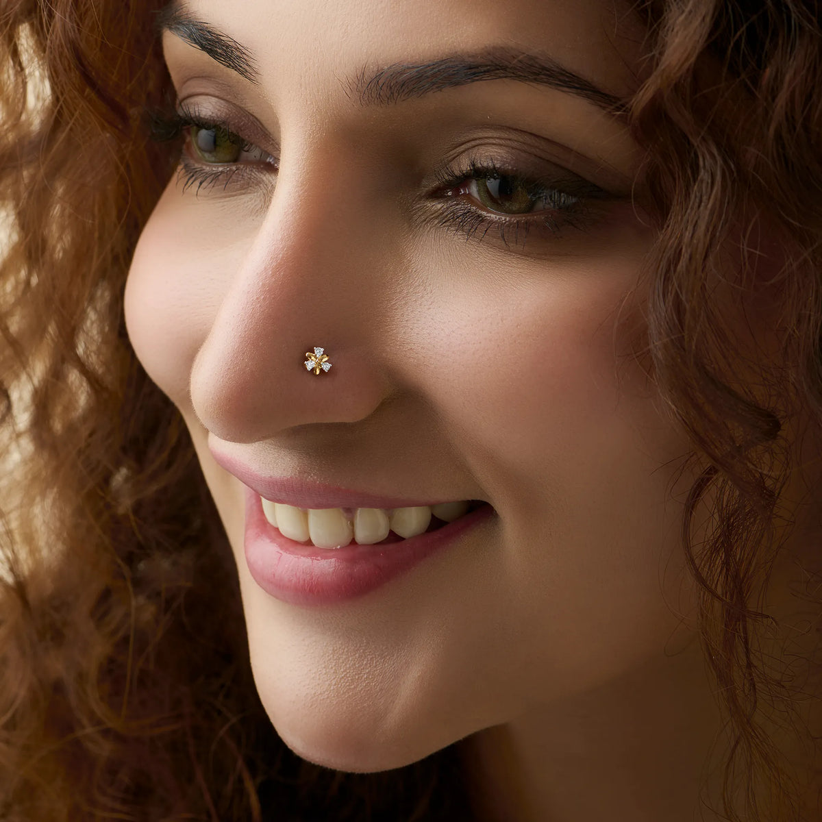 Elegant gold nose pin with blossom diamond detail, jewelry close-up