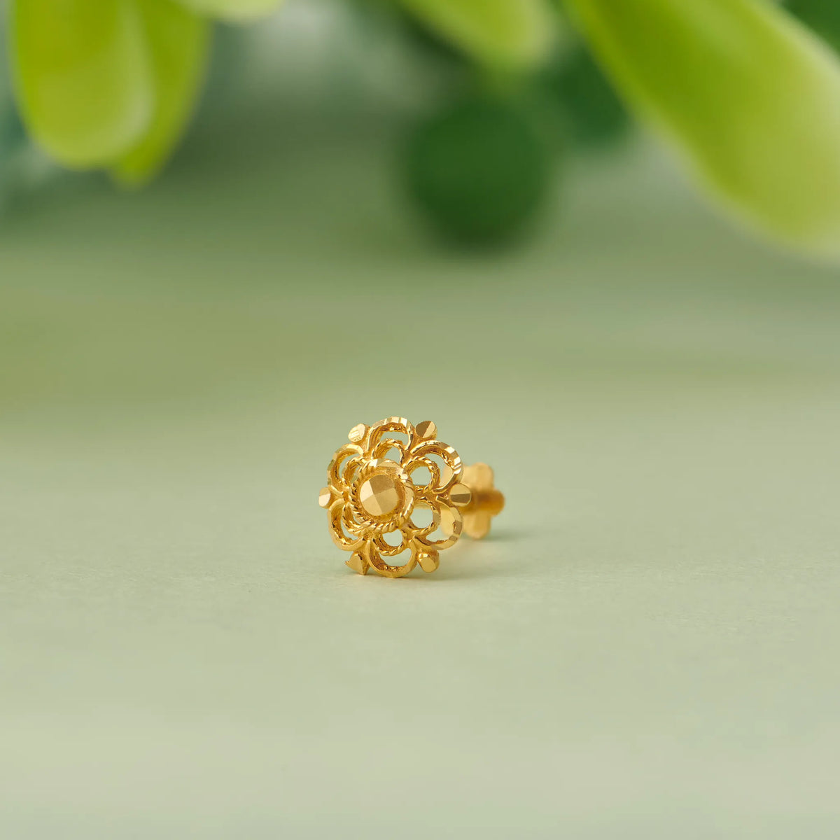 Gold flower-shaped stud earring with layered petal filigree design