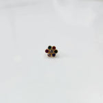 Woman wearing nose pin design gold with floral stone pattern close up