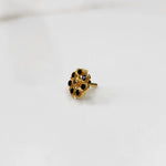 Gold flower ring with black gemstones, front view