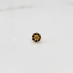 Gold flower ring with black gemstones and gold star center