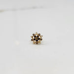 Gold flower ring with blue center stones and surrounding gemstones