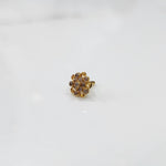 Gold flower ring with clear gemstones in halo setting