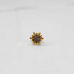 Gold flower ring with clear gemstones, front view