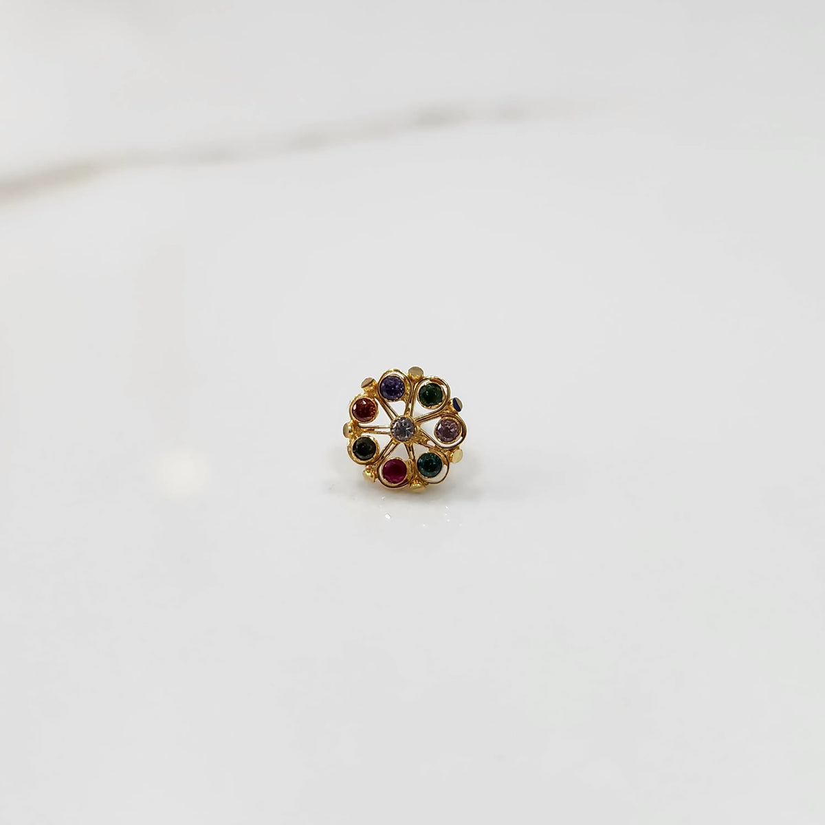 Gold flower ring with multicolor cabochon gemstones, front view