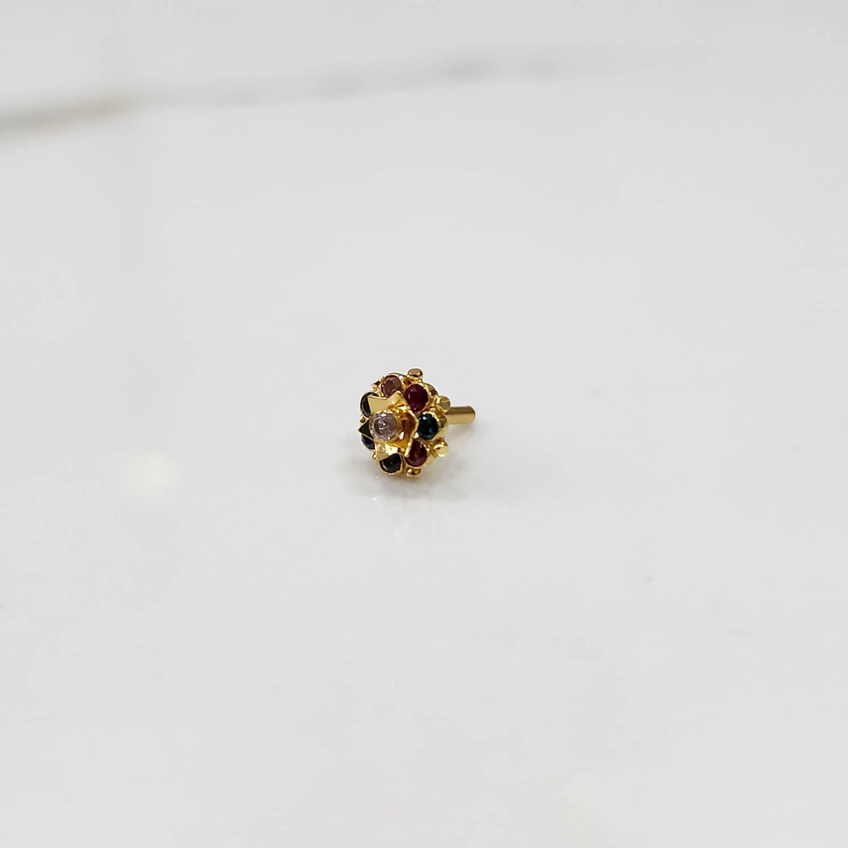 Close-up of gold ring with multicolor gemstone flower cluster