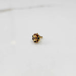 Close-up of gold ring with multicolor gemstone flower cluster