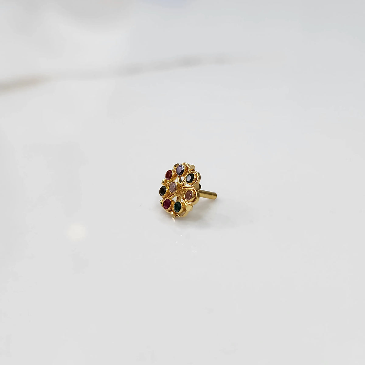 Full front view of gold ring with multicolor gemstone petals