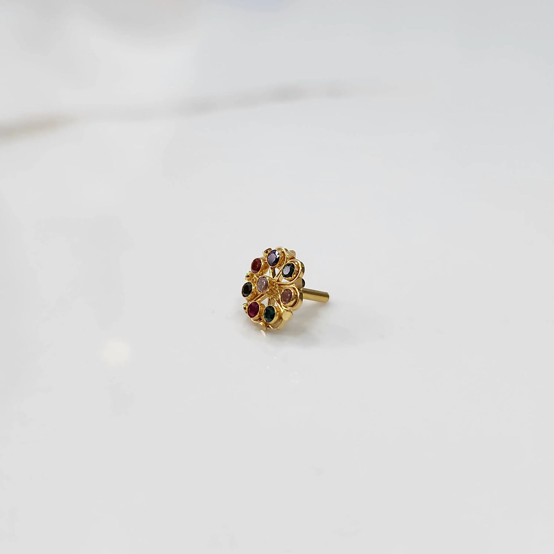 Full front view of gold ring with multicolor gemstone petals