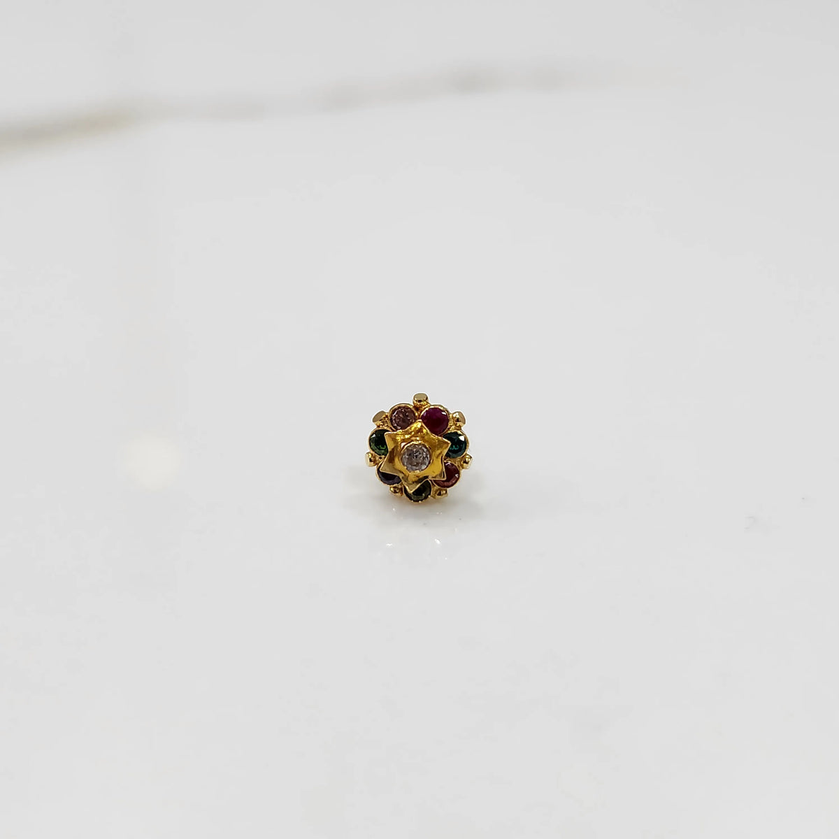 Gold flower ring with multicolor gemstones and small gold center