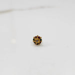 Gold flower ring with multicolor gemstones and small gold center