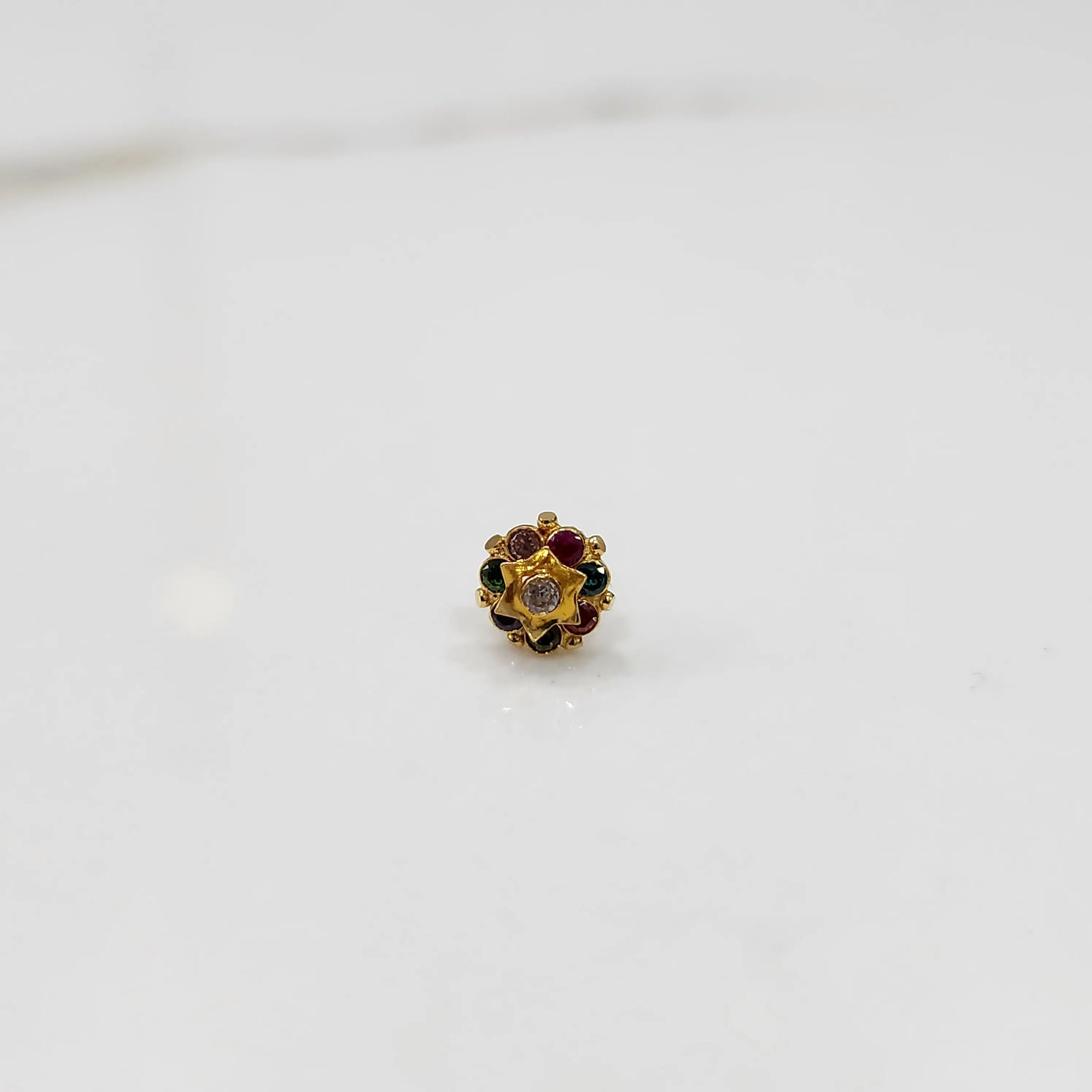 Gold flower ring with multicolor gemstones and small gold center