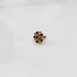 Antique-style gold ring featuring amethyst-toned stones in halo design