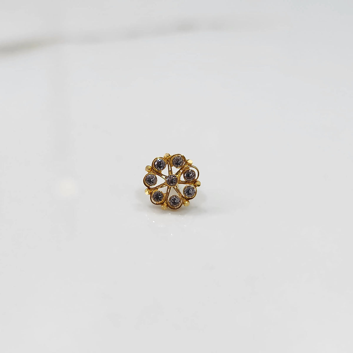 Front view of gold ring with purple gemstone petals