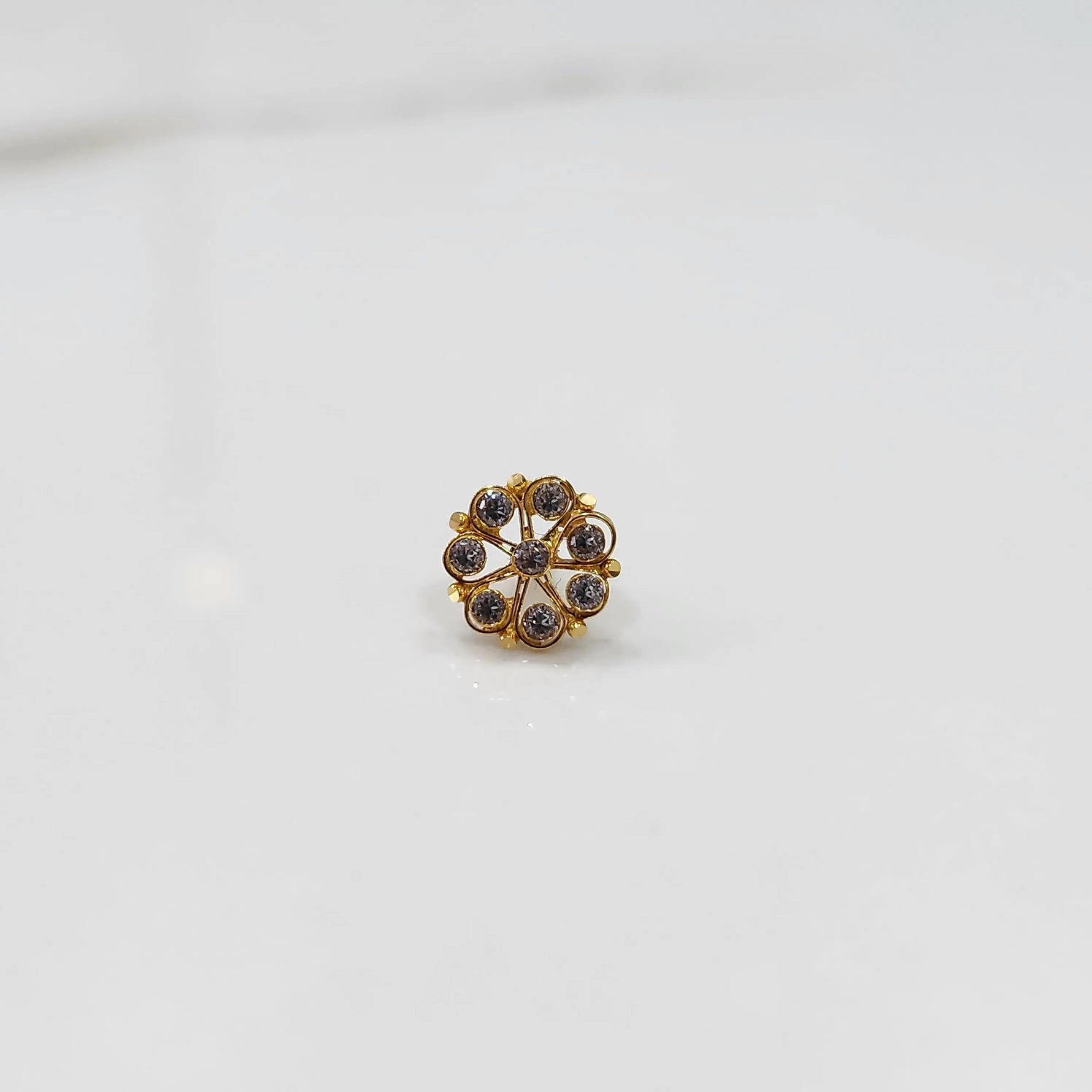 Front view of gold ring with purple gemstone petals