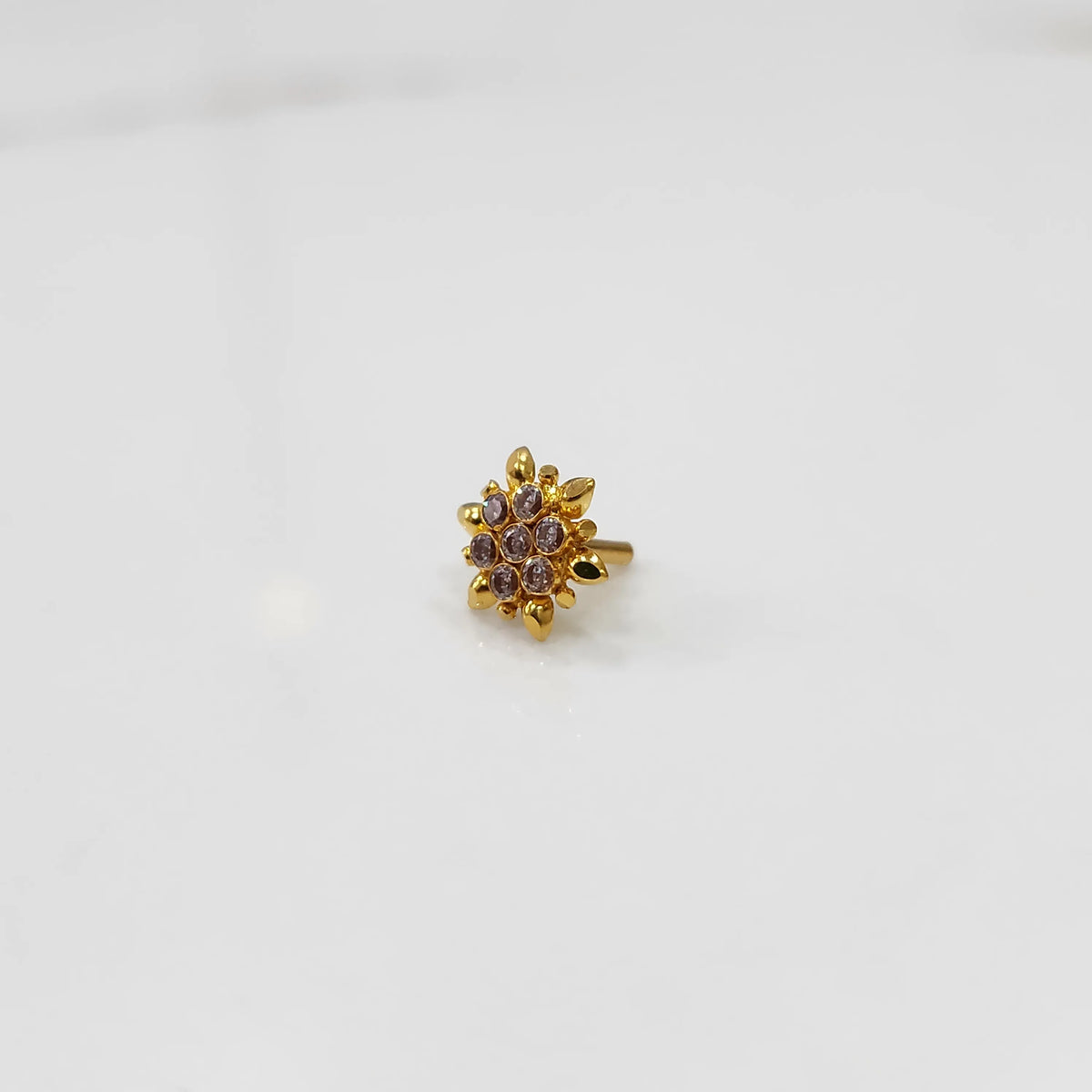 Gold flower ring with purple gemstones, front view