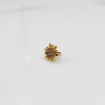 Gold flower ring with purple gemstones, front view