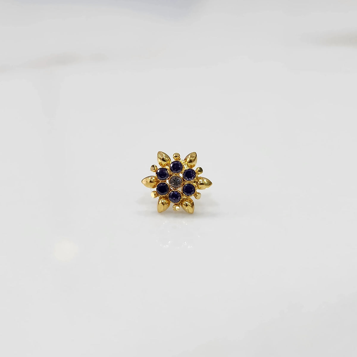 Gold flower ring with purple gemstones, full front view