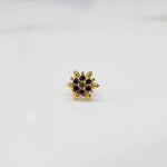 Gold flower ring with purple gemstones, full front view