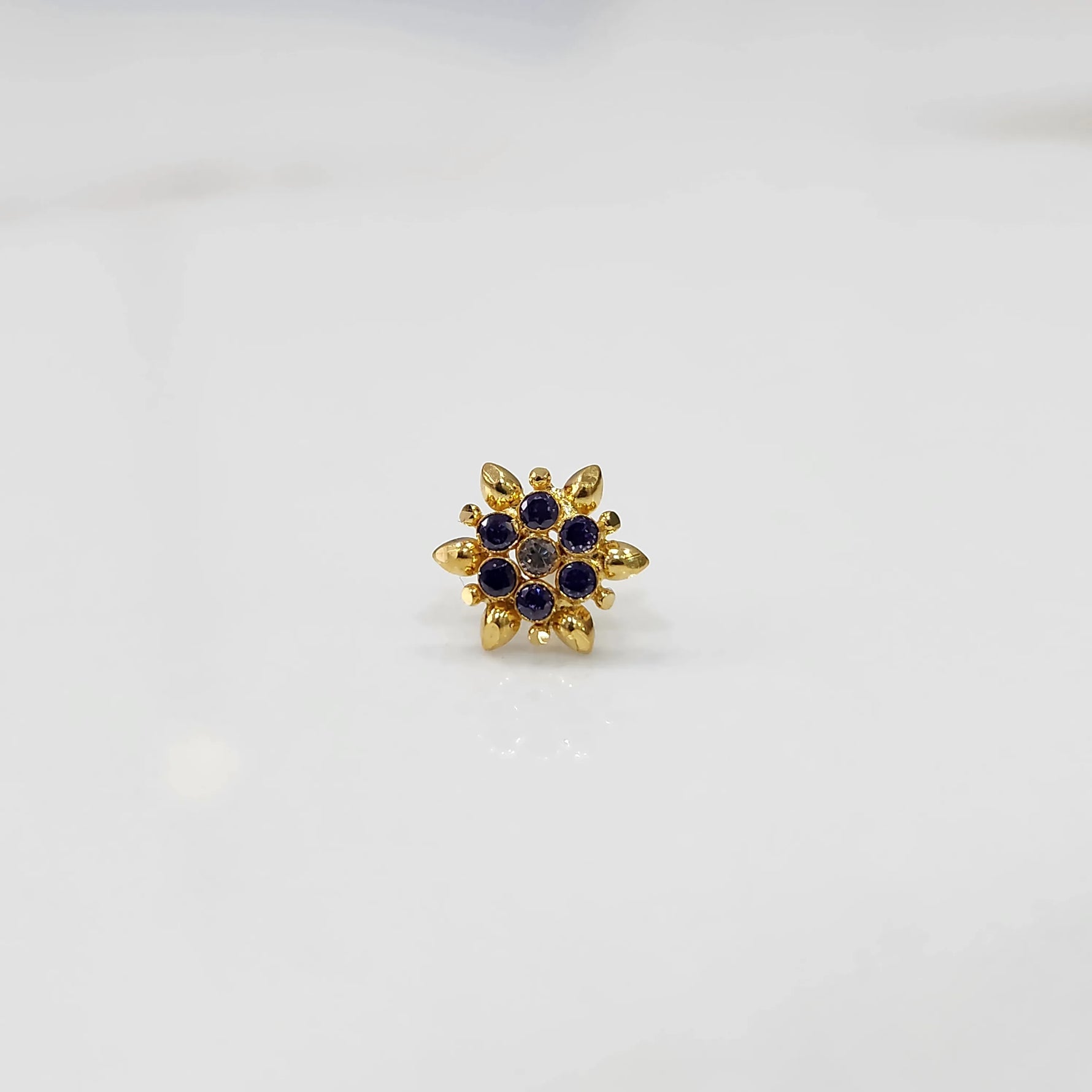 Gold flower ring with purple gemstones, full front view
