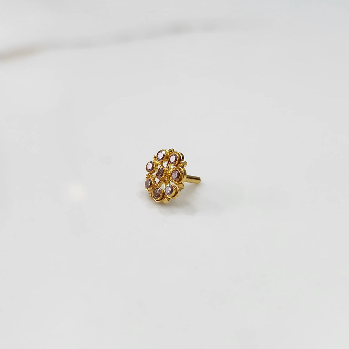 Gold flower ring with purple gemstones, front view
