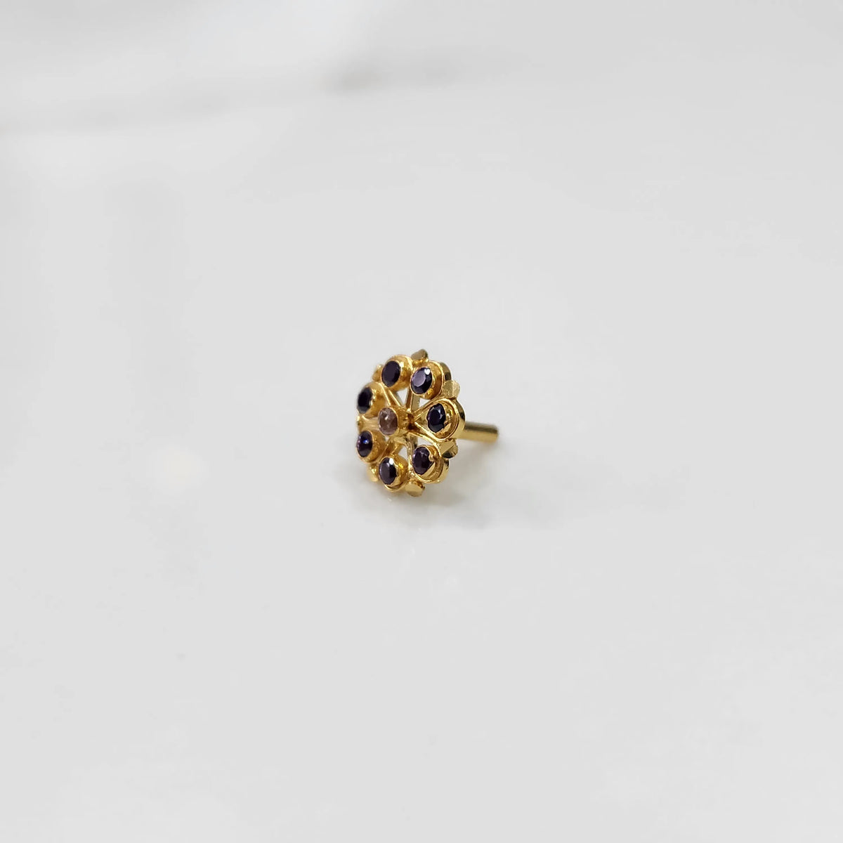 Gold flower ring with purple gemstones, front view
