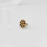 Gold flower ring with purple gemstones, front view
