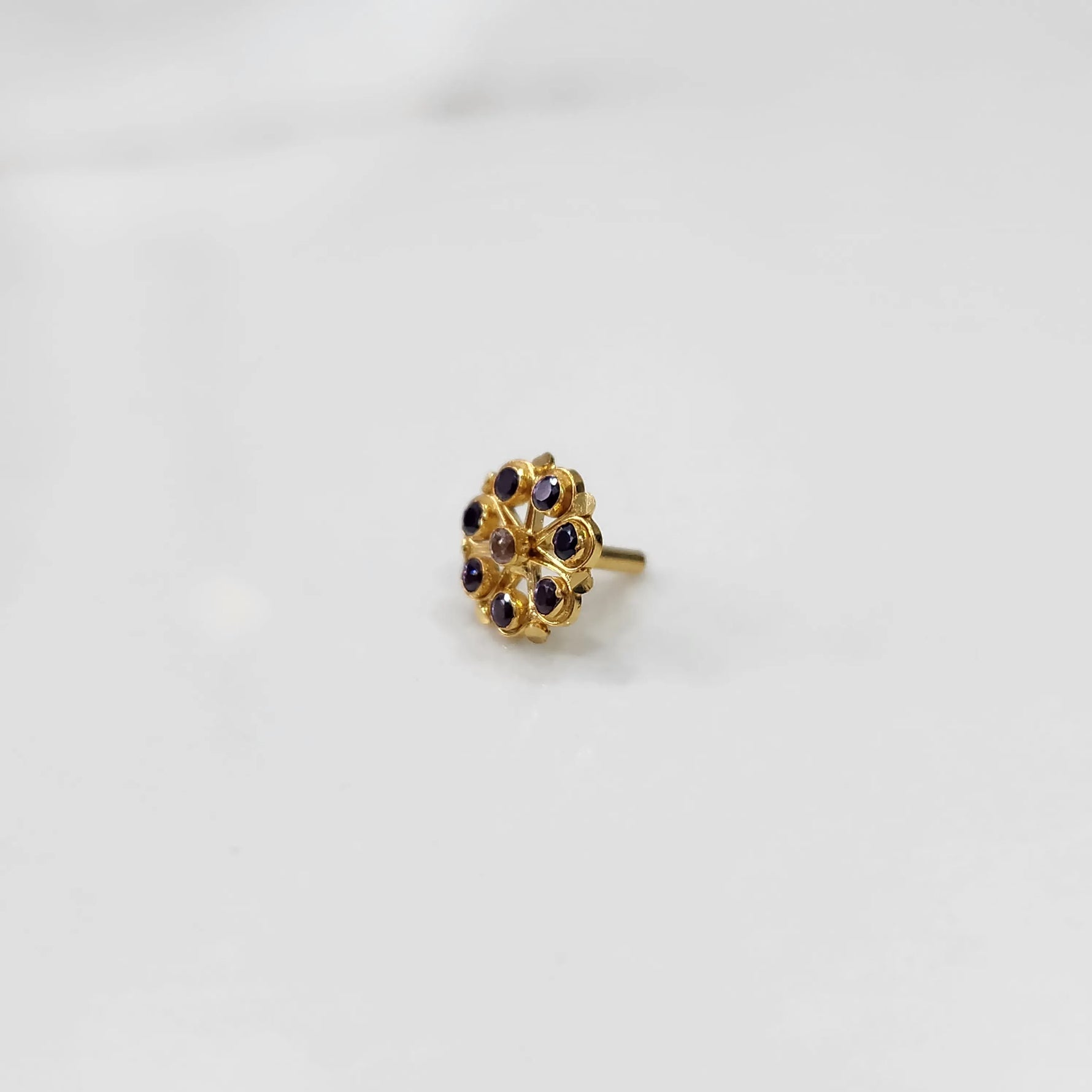Gold flower ring with purple gemstones, front view