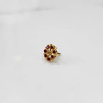 Gold flower ring with red gemstones, front view