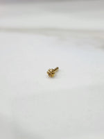 Gold four-leaf clover flower nose pin, angled view showing pin