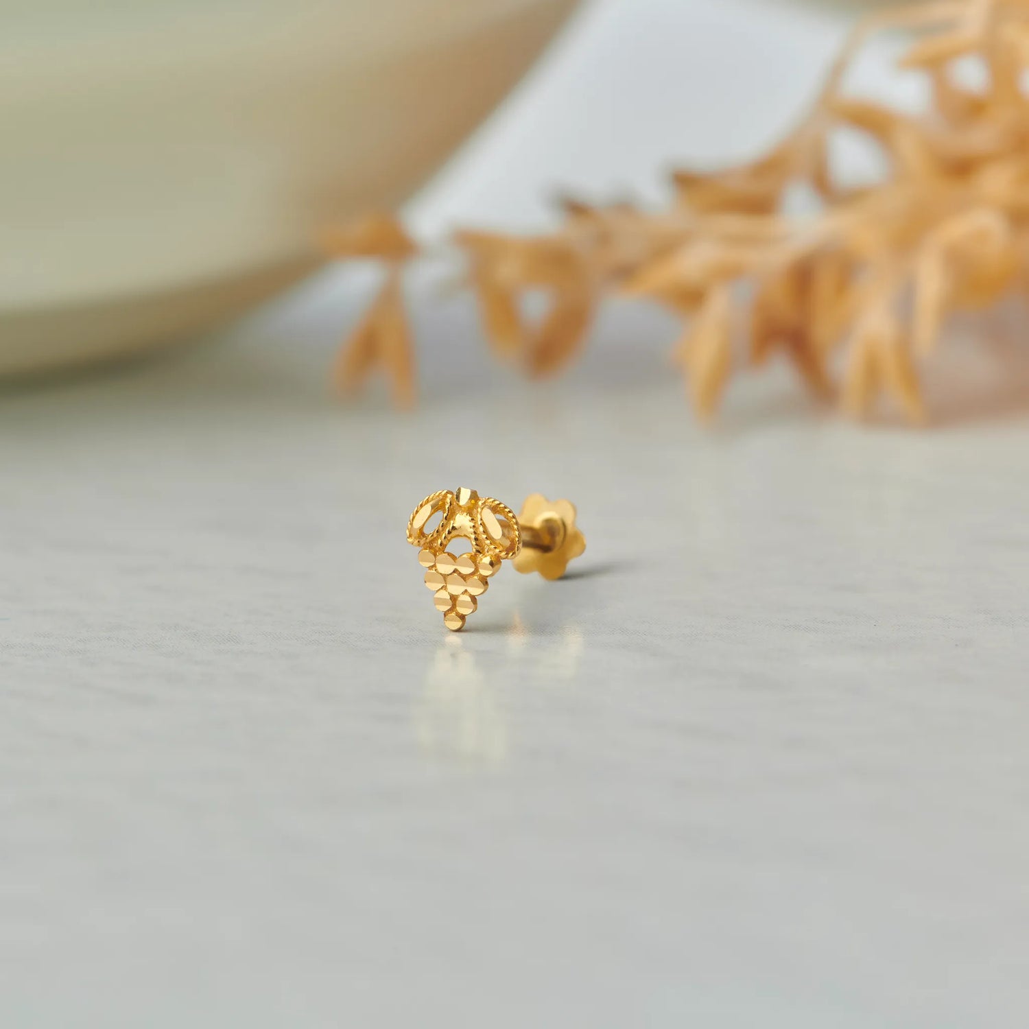 Gold stud earring with grape cluster design