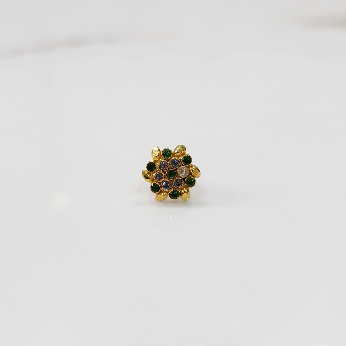 Gold statement ring with green and multicolor gemstones in round textured floral design