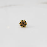 Gold statement ring with green and multicolor gemstones in round textured floral design