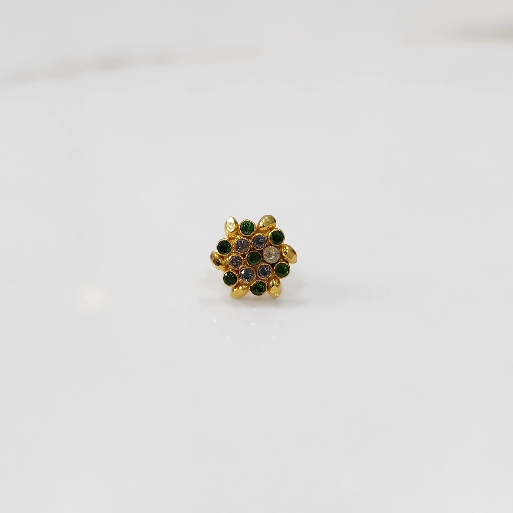Gold statement ring with green and multicolor gemstones in round textured floral design