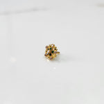 Gold statement ring with green and multicolor gemstones in textured floral cluster design
